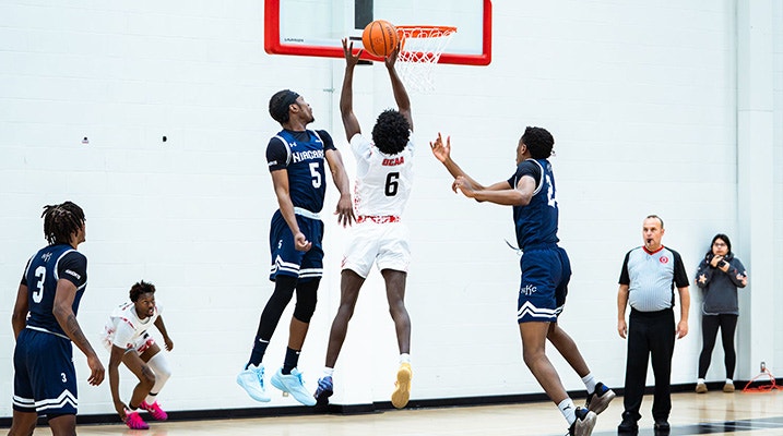 Canadore Men's Basketball game, player scoring a basket